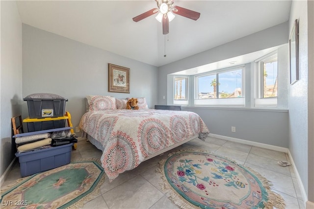 bedroom featuring light tile patterned floors and ceiling fan