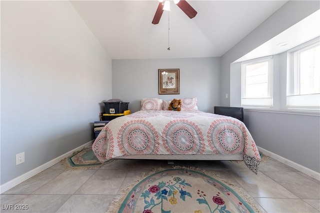 tiled bedroom with vaulted ceiling and ceiling fan