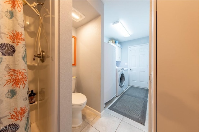 bathroom with tile patterned floors, toilet, a shower with shower curtain, and washer and dryer