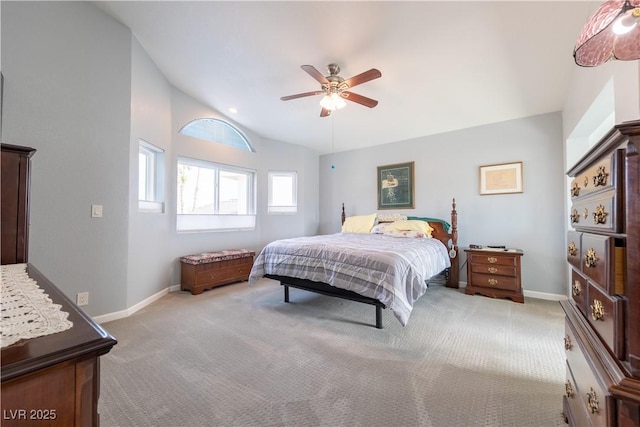 bedroom with ceiling fan, light colored carpet, and vaulted ceiling