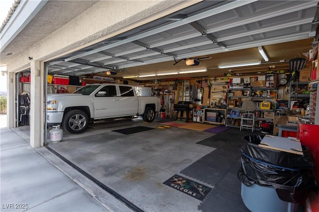 garage with a garage door opener and a workshop area