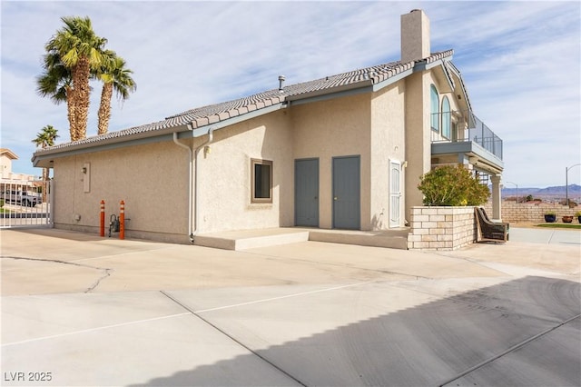 back of house with a balcony and a patio area