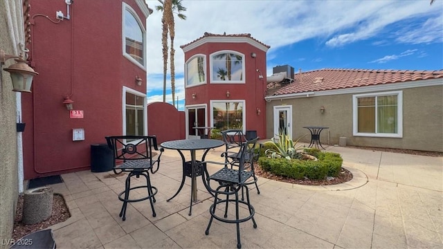4730 E Craig Rd Unit 1172, Las Vegas, NV 89115 - back of property featuring a tiled roof, stucco siding, and a patio area