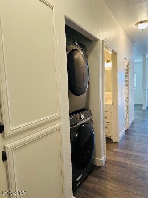 4730 E Craig Rd Unit 1172, Las Vegas, NV 89115 - clothes washing area with stacked washer and clothes dryer, dark wood-type flooring, and baseboards