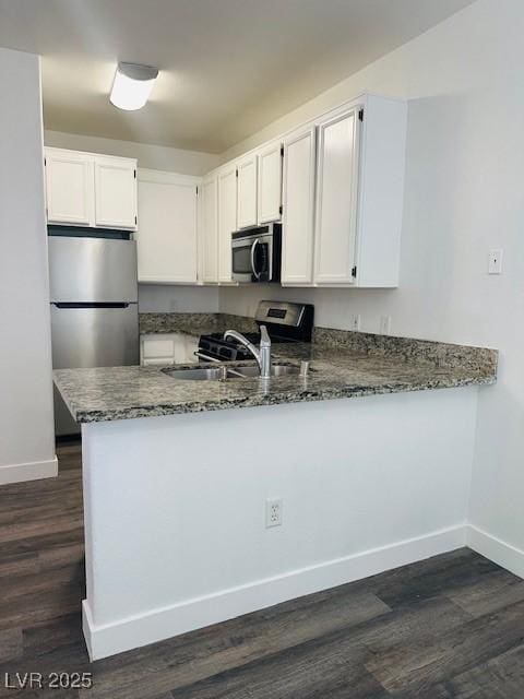 4730 E Craig Rd Unit 1172, Las Vegas, NV 89115 - kitchen featuring stainless steel appliances, dark stone counters, and baseboards