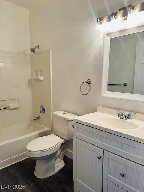 4730 E Craig Rd Unit 1172, Las Vegas, NV 89115 - full bathroom featuring wood finished floors, toilet, vanity, and shower / tub combination