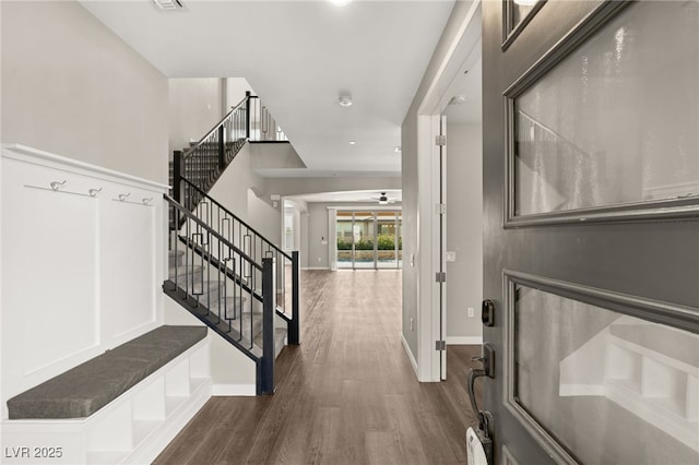 foyer featuring dark wood-type flooring and ceiling fan