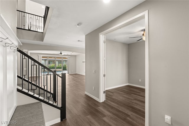 staircase featuring hardwood / wood-style flooring and ceiling fan