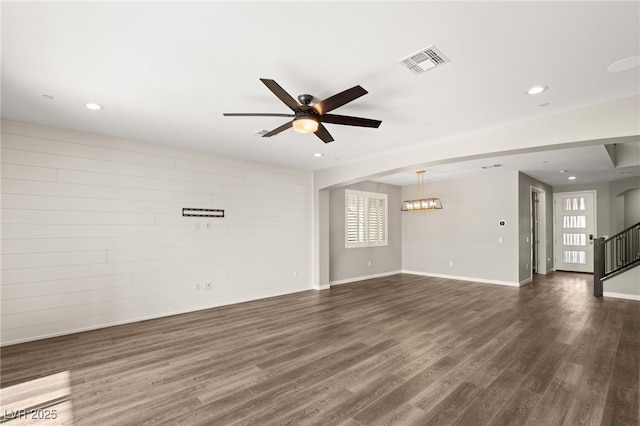 unfurnished living room with ceiling fan and dark hardwood / wood-style floors