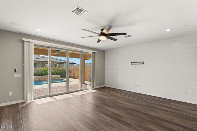 unfurnished room featuring dark hardwood / wood-style floors and ceiling fan