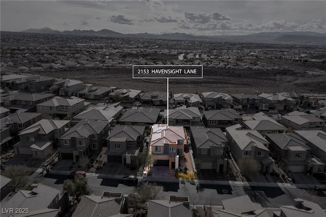 birds eye view of property with a mountain view