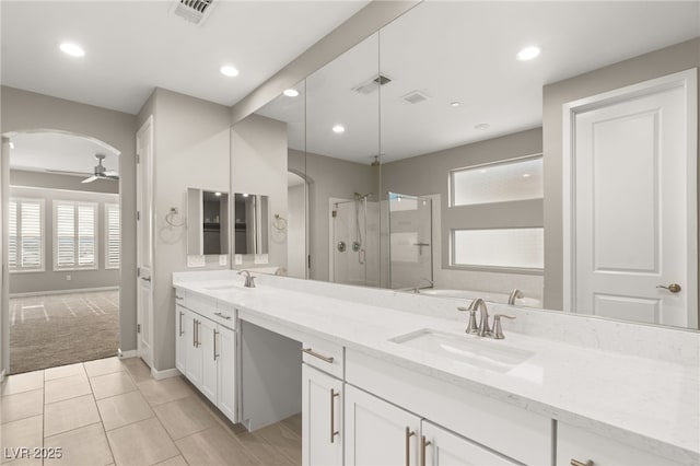 bathroom featuring tile patterned flooring, vanity, ceiling fan, and a shower with shower door