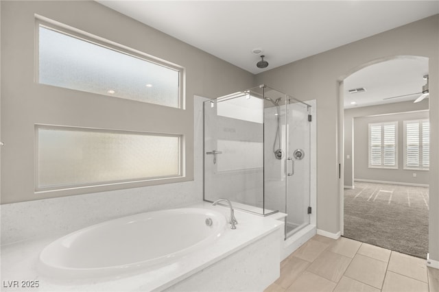 bathroom featuring tile patterned flooring, plus walk in shower, and ceiling fan