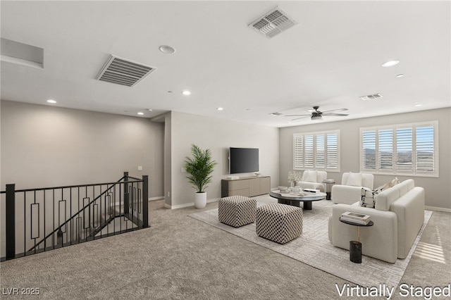 carpeted living room with ceiling fan