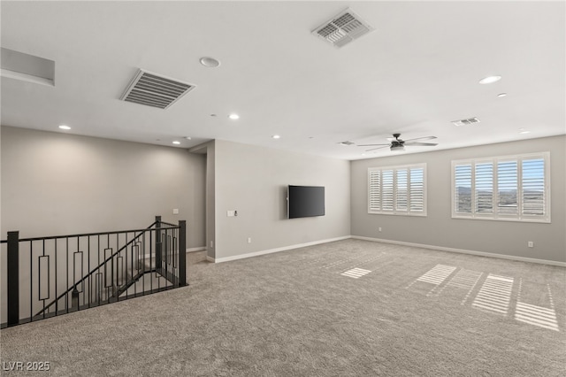 carpeted spare room with ceiling fan