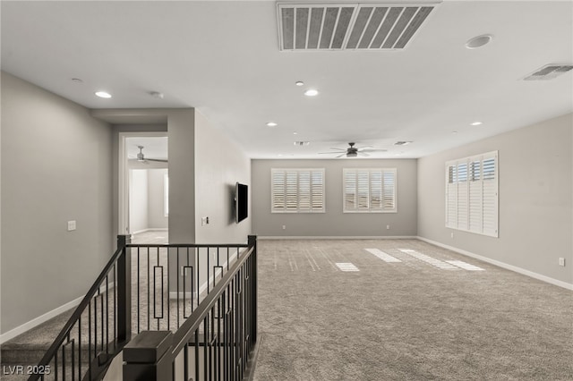 empty room with ceiling fan and carpet