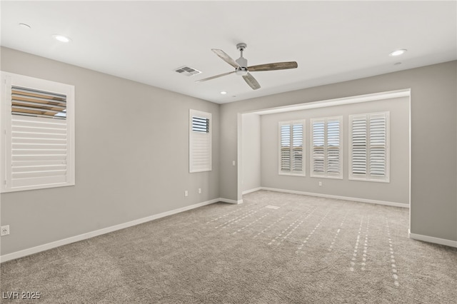 unfurnished room featuring light carpet and ceiling fan