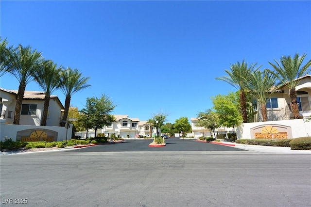 view of street featuring curbs, sidewalks, and a residential view