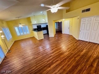 kitchen with dark wood-style flooring, visible vents, a ceiling fan, high vaulted ceiling, and a peninsula