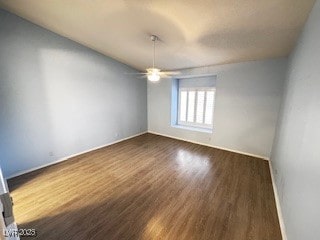 unfurnished room with a ceiling fan, dark wood-style flooring, and baseboards