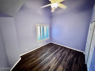 unfurnished bedroom with ceiling fan and dark wood-style flooring