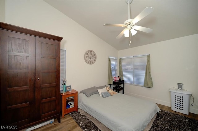 bedroom with lofted ceiling, light hardwood / wood-style floors, and ceiling fan