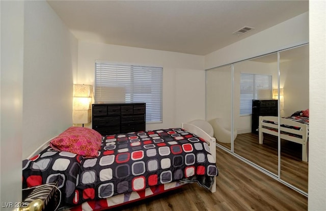 bedroom featuring hardwood / wood-style flooring and a closet