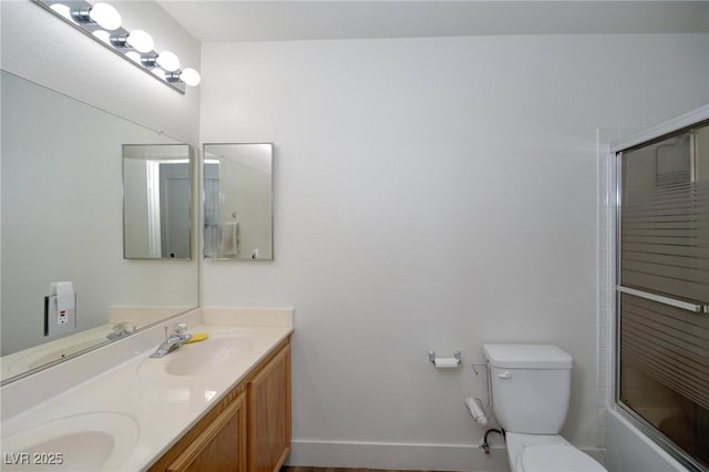 full bathroom featuring vanity, enclosed tub / shower combo, and toilet