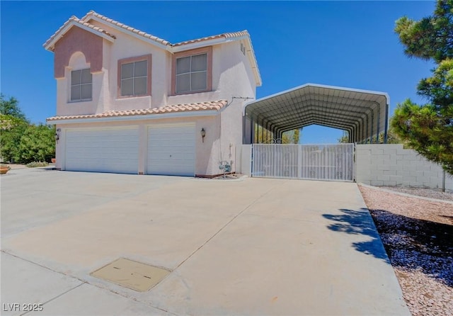 mediterranean / spanish house featuring a carport and a garage