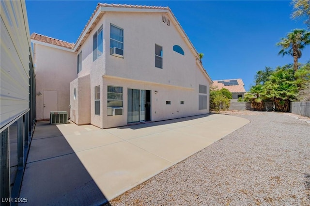 rear view of property with a patio and central air condition unit