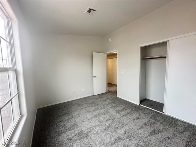 unfurnished bedroom featuring a closet, carpet, visible vents, and baseboards