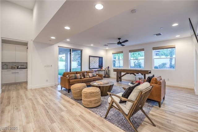 living room featuring ceiling fan and light wood-type flooring