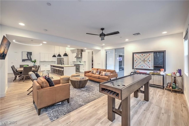 game room featuring ceiling fan and light wood-type flooring