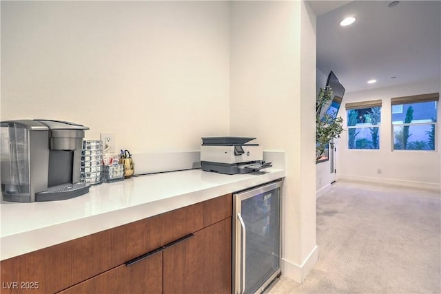 kitchen with light carpet and wine cooler