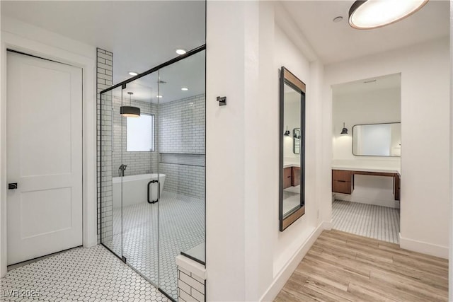 bathroom with vanity, wood-type flooring, and walk in shower