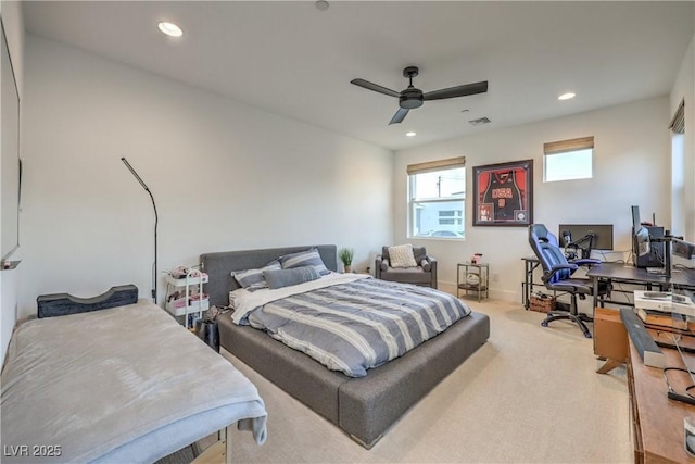 bedroom featuring light colored carpet and ceiling fan