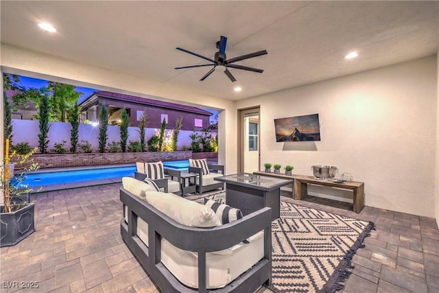 view of patio featuring an outdoor living space, a fenced in pool, and ceiling fan