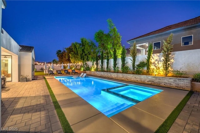 view of pool with an in ground hot tub and a patio area