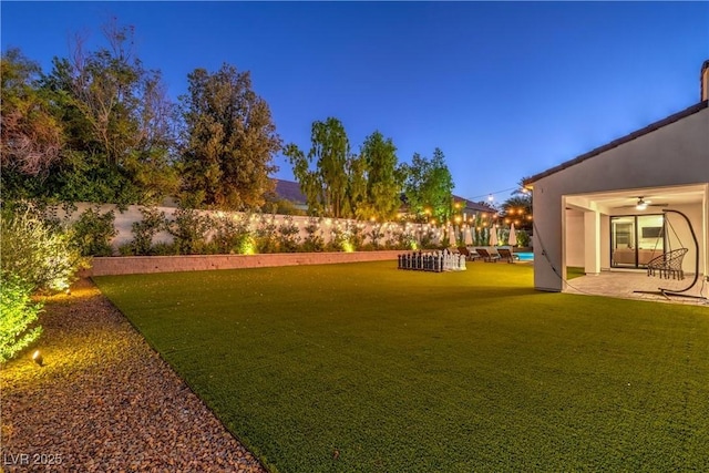 view of yard with ceiling fan and a patio