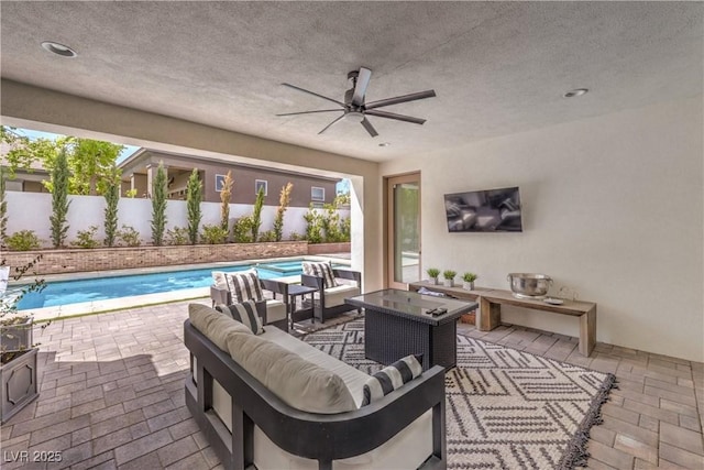 view of patio / terrace featuring a fenced in pool, outdoor lounge area, and ceiling fan