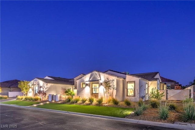 view of front of home featuring central AC unit and a front lawn