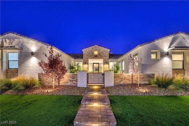 view of front of property with a yard