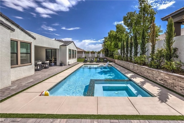 view of swimming pool featuring an in ground hot tub and a patio area