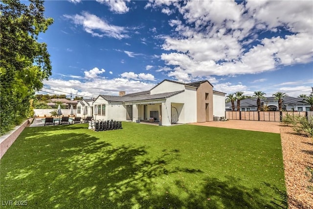 back of property featuring a patio and a lawn