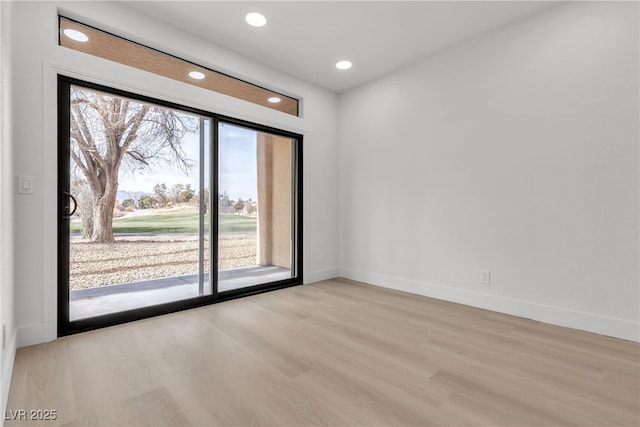 unfurnished room with light hardwood / wood-style flooring