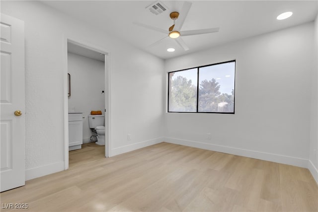 unfurnished bedroom featuring ensuite bathroom, light hardwood / wood-style flooring, and ceiling fan