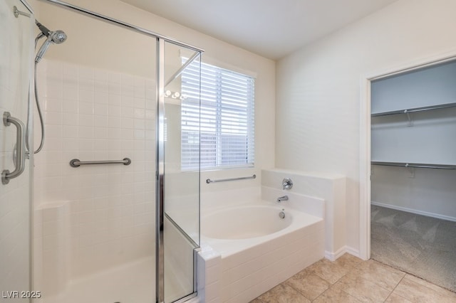 bathroom with tile patterned floors and shower with separate bathtub