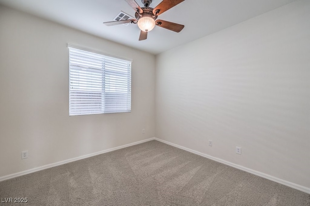 spare room featuring ceiling fan and carpet floors