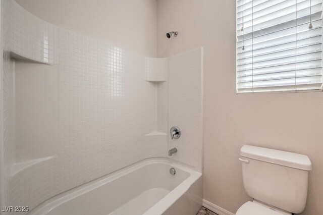 bathroom featuring bathing tub / shower combination and toilet