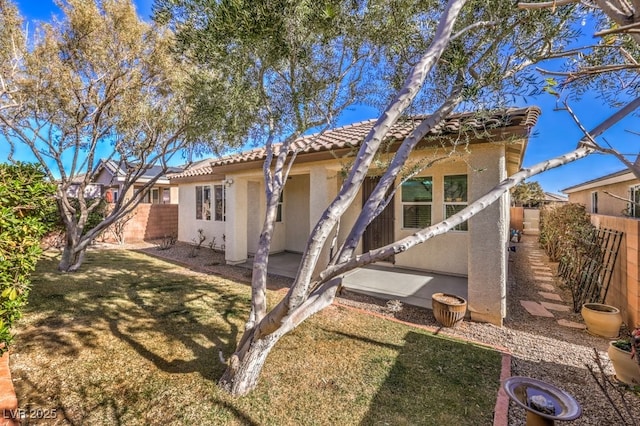 rear view of property featuring a yard